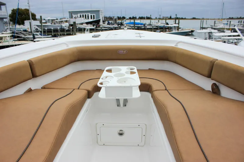 Slide: The Image of 2020 Sea Hunt Ultra 275 SE boat interior with tan seating and cup holders. - 40