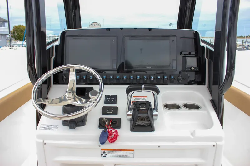 Slide: The Image of 2020 Sea Hunt Ultra 275 SE boat dashboard with steering wheel and controls. - 43
