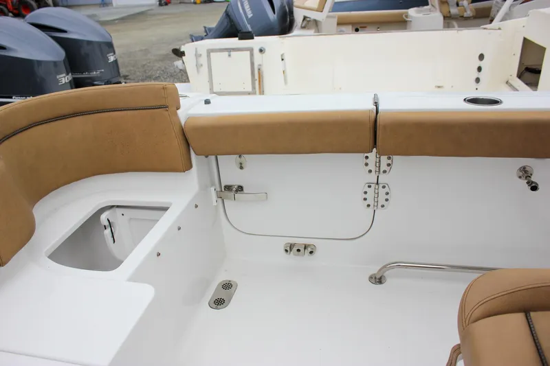Slide: The Image of 2020 Sea Hunt Ultra 275 SE boat interior with tan seating and storage compartments. - 45