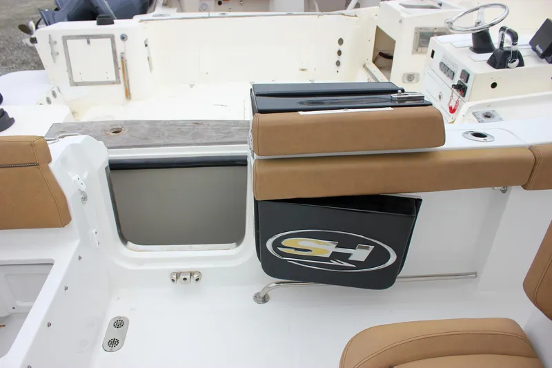 Slide: The Image of 2020 Sea Hunt Ultra 275 SE boat interior with tan seating and control panel. - 46