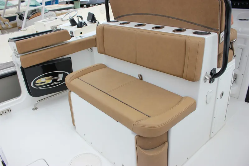 Slide: The Image of 2020 Sea Hunt Ultra 275 SE boat interior with tan seating and cup holders. - 47