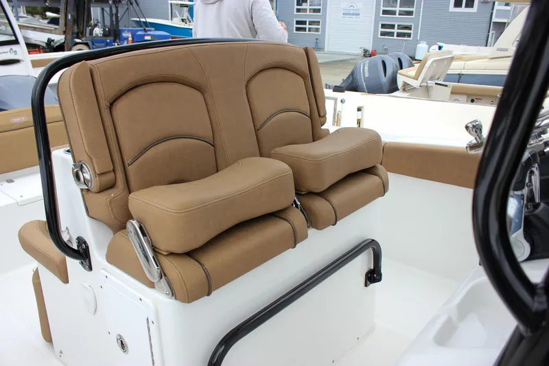 Slide: The Image of 2020 Sea Hunt Ultra 275 SE boat with tan cushioned seating and sleek design. - 50