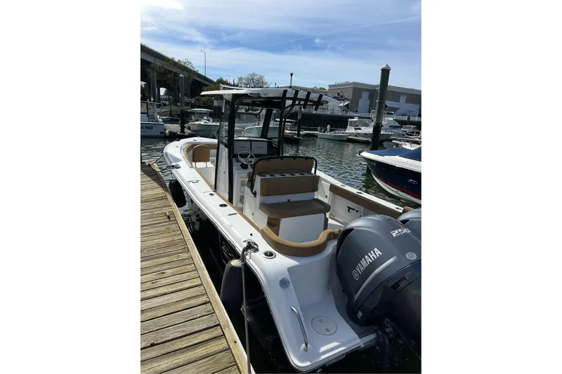 Slide: The Image of 2020 Sea Hunt Ultra 275 SE boat docked with Yamaha engine, in a marina setting. - 52