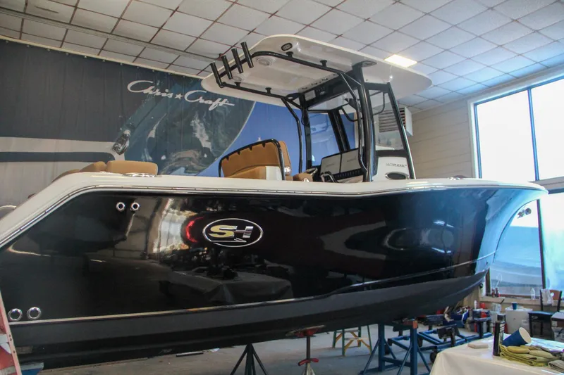 Slide: The Image of 2020 Sea Hunt Ultra 275 SE boat displayed indoors, showcasing sleek design and modern features. - 56