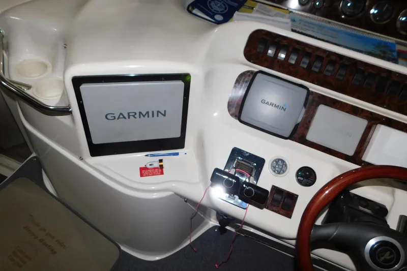 Slide: The Image of 1997 Sea Ray 400 Sundancer helm with Garmin navigation system and wooden steering wheel. - 10