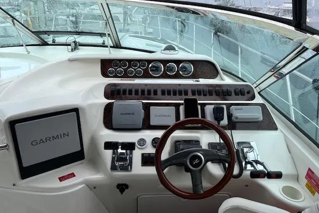 Slide: The Image of Cockpit of 1997 Sea Ray 400 Sundancer with Garmin navigation system and steering wheel. - 11