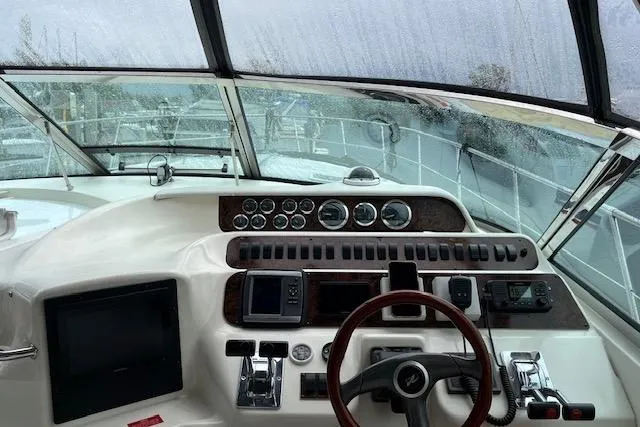 Slide: The Image of Cockpit view of 1997 Sea Ray 400 Sundancer with steering wheel and control panel. - 12
