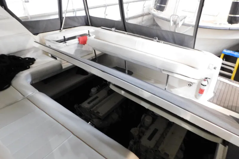 Slide: The Image of 1997 Sea Ray 400 Sundancer engine compartment with seating and fire extinguisher. - 14