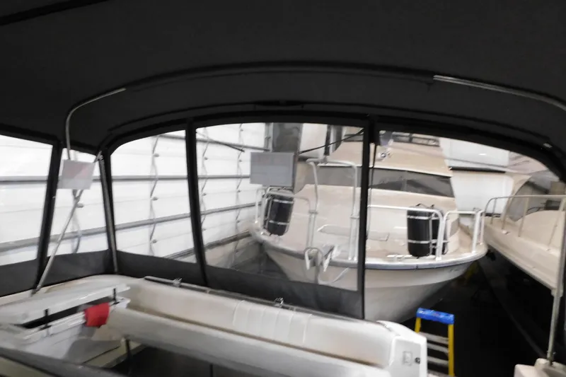 Slide: The Image of 1997 Sea Ray 400 Sundancer yacht in indoor storage, viewed from the stern. - 15