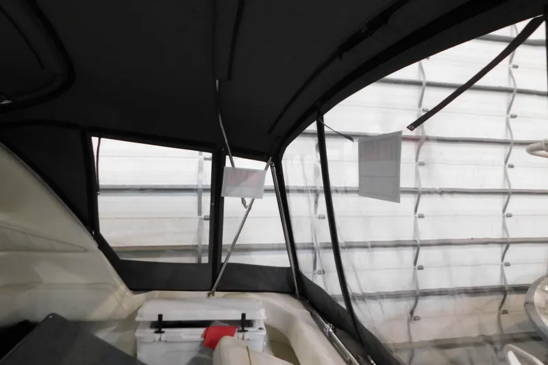 Slide: The Image of Interior view of a 1997 Sea Ray 400 Sundancer boat with clear windows and seating. - 16
