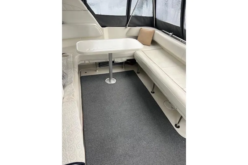 Slide: The Image of 1997 Sea Ray 400 Sundancer interior with white seating and table. - 19