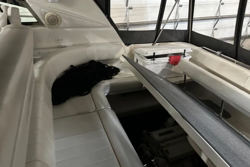 Slide: The Image of 1997 Sea Ray 400 Sundancer interior with white seating and storage area. - 20