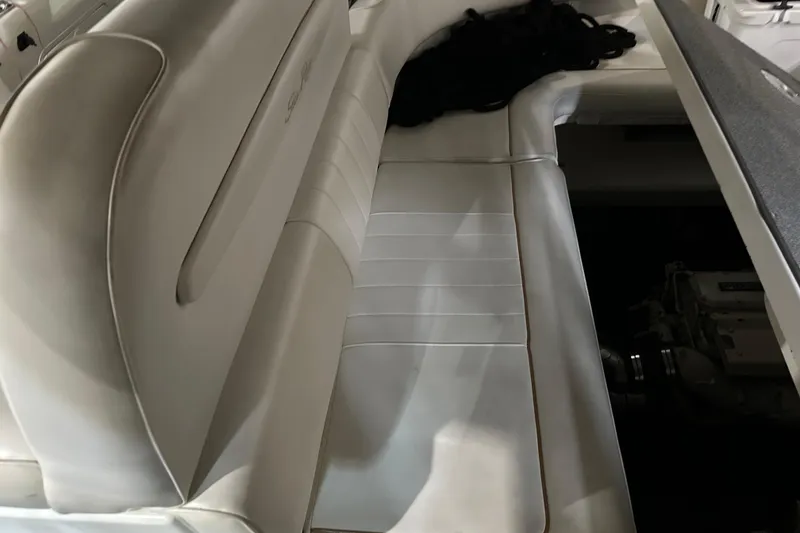 Slide: The Image of 1997 Sea Ray 400 Sundancer interior seating with white upholstery and engine compartment. - 21