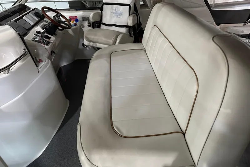Slide: The Image of 1997 Sea Ray 400 Sundancer interior with white leather seating and helm station. - 23