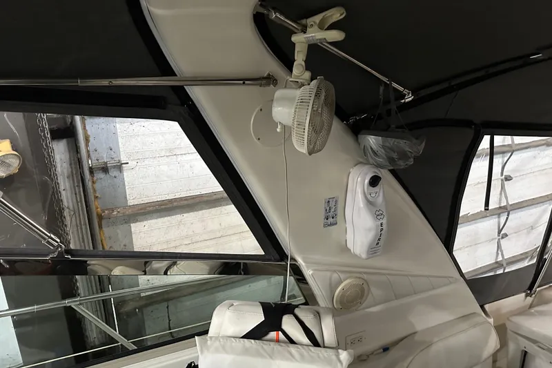 Slide: The Image of 1997 Sea Ray 400 Sundancer interior with fan and EPIRB device. - 24