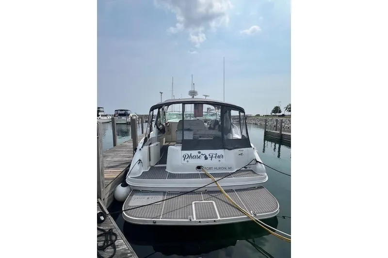 Slide: The Image of 1997 Sea Ray 400 Sundancer docked at marina, rear view with clear skies. - 3