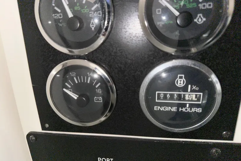 Slide: The Image of 1997 Sea Ray 400 Sundancer dashboard gauges showing engine hours and battery voltage. - 30