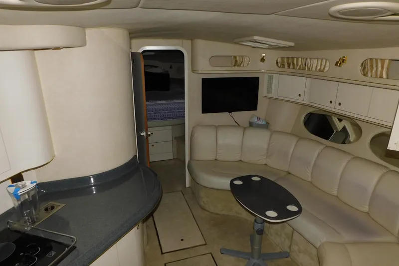 Slide: The Image of Interior of 1997 Sea Ray 400 Sundancer yacht with beige seating and modern amenities. - 33