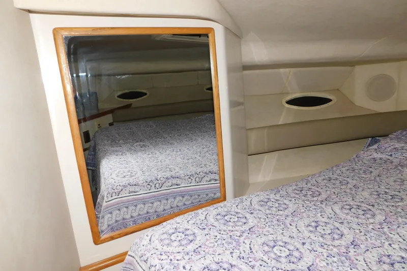Slide: The Image of 1997 Sea Ray 400 Sundancer cabin interior with mirror and patterned bedding. - 36