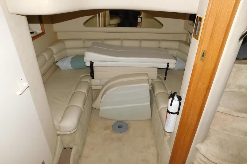Slide: The Image of 1997 Sea Ray 400 Sundancer cabin interior with beige seating and fire extinguisher. - 38