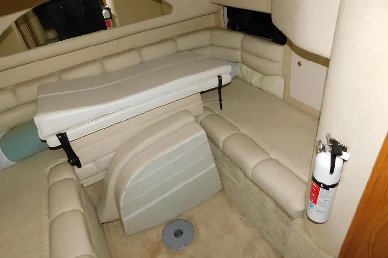 Slide: The Image of Interior cabin of 1997 Sea Ray 400 Sundancer with beige seating and fire extinguisher. - 39