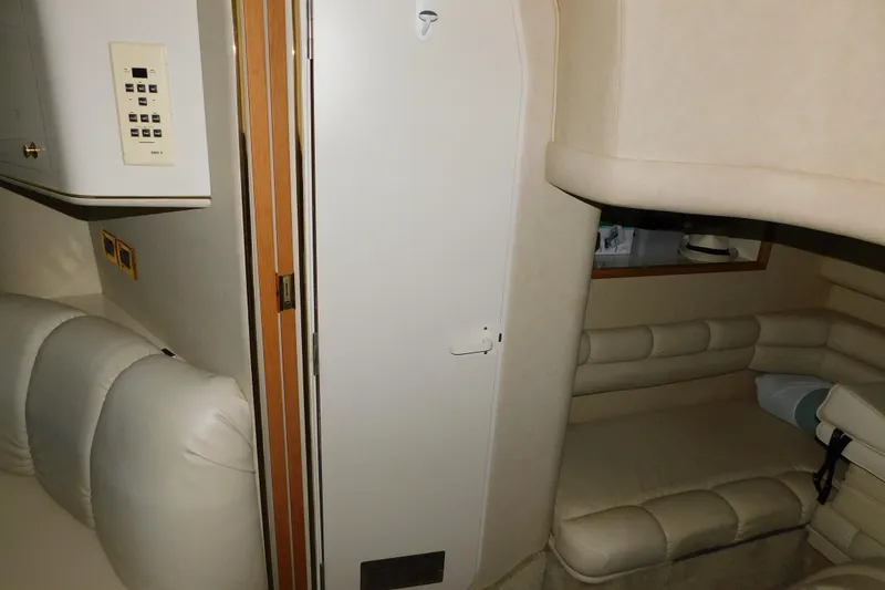 Slide: The Image of Interior of 1997 Sea Ray 400 Sundancer yacht with beige seating and control panel. - 40