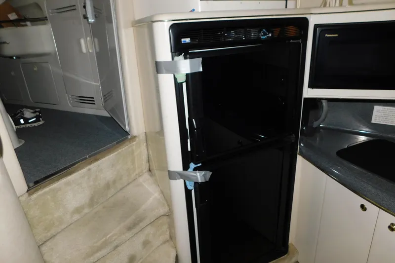 Slide: The Image of Interior of 1997 Sea Ray 400 Sundancer with open refrigerator in the galley area. - 42