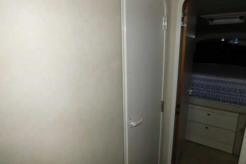 Slide: The Image of Interior cabin view of 1997 Sea Ray 400 Sundancer yacht, featuring a bed and storage. - 44