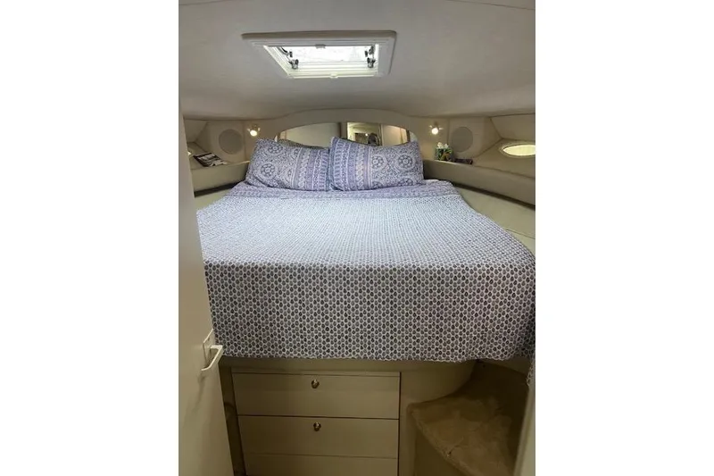 Slide: The Image of Cozy bedroom interior of 1997 Sea Ray 400 Sundancer yacht with patterned bedding. - 51