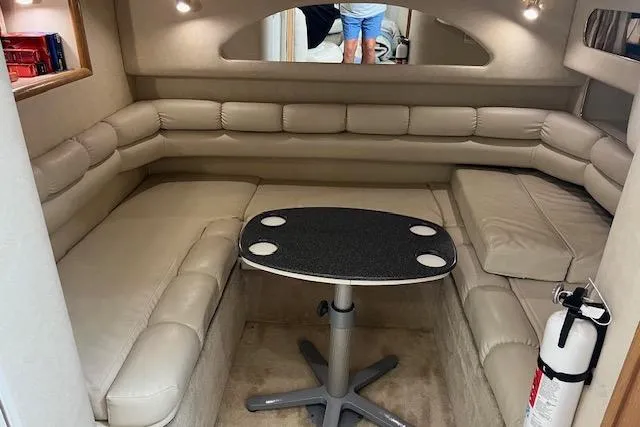 Slide: The Image of 1997 Sea Ray 400 Sundancer interior with beige seating and a central table. - 53