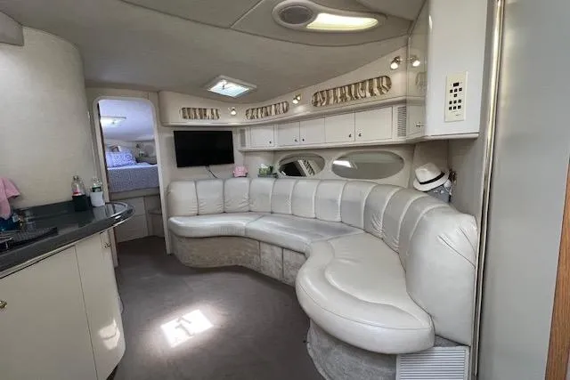Slide: The Image of Luxurious interior of 1997 Sea Ray 400 Sundancer yacht with curved seating and modern amenities. - 55