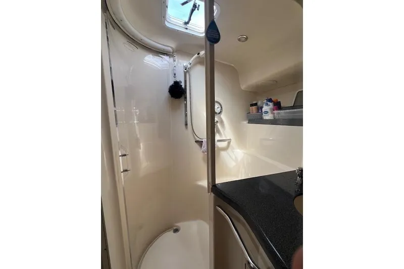 Slide: The Image of Bathroom interior of 1997 Sea Ray 400 Sundancer yacht, featuring shower and sink. - 57