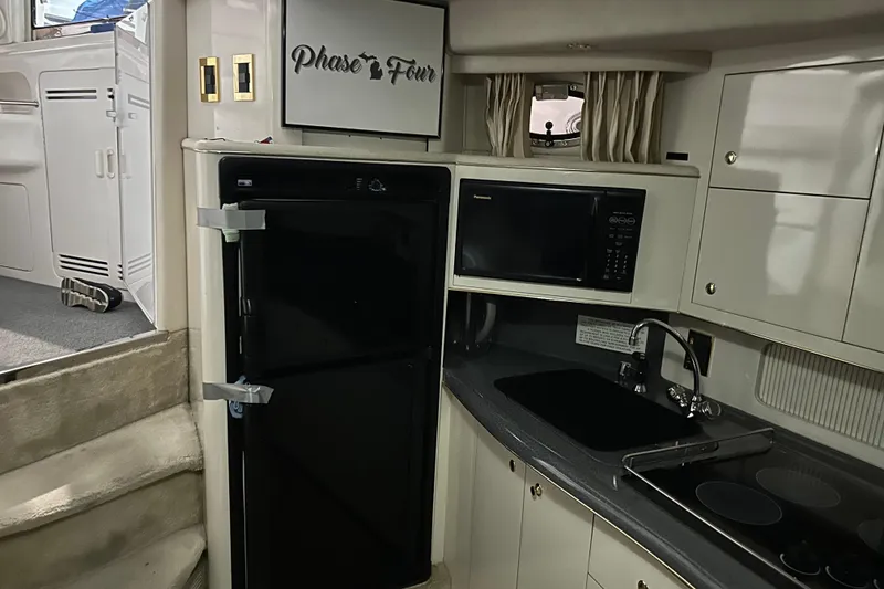 Slide: The Image of Interior of 1997 Sea Ray 400 Sundancer yacht kitchen with appliances and cabinetry. - 58