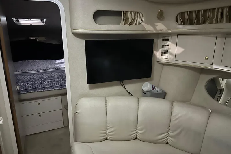 Slide: The Image of Interior of 1997 Sea Ray 400 Sundancer yacht with TV and cozy seating area. - 61