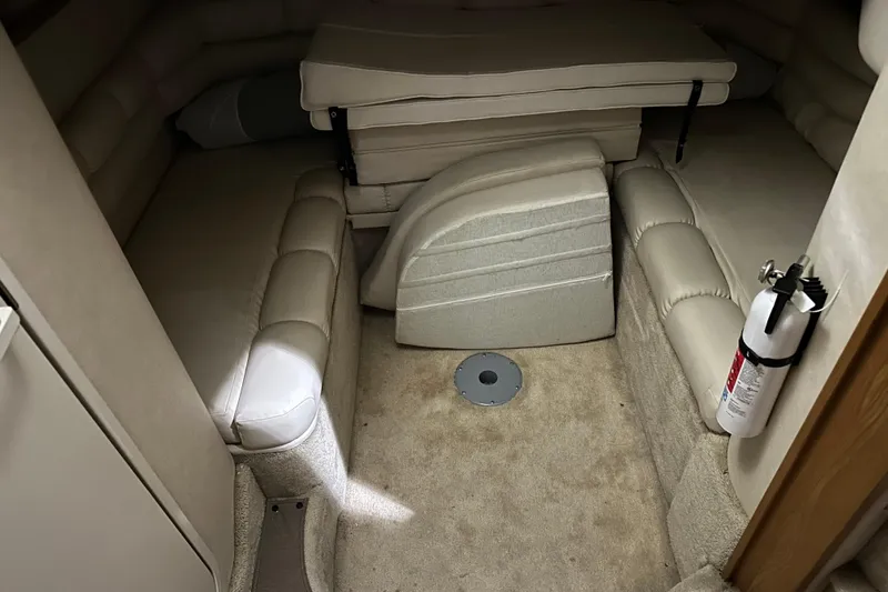 Slide: The Image of 1997 Sea Ray 400 Sundancer cabin interior with beige seating and fire extinguisher. - 62