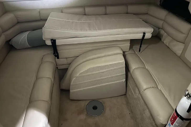 Slide: The Image of 1997 Sea Ray 400 Sundancer cabin interior with beige seating and convertible table. - 63