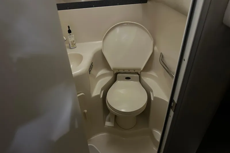 Slide: The Image of Bathroom interior of 1997 Sea Ray 400 Sundancer yacht, featuring toilet and sink. - 64