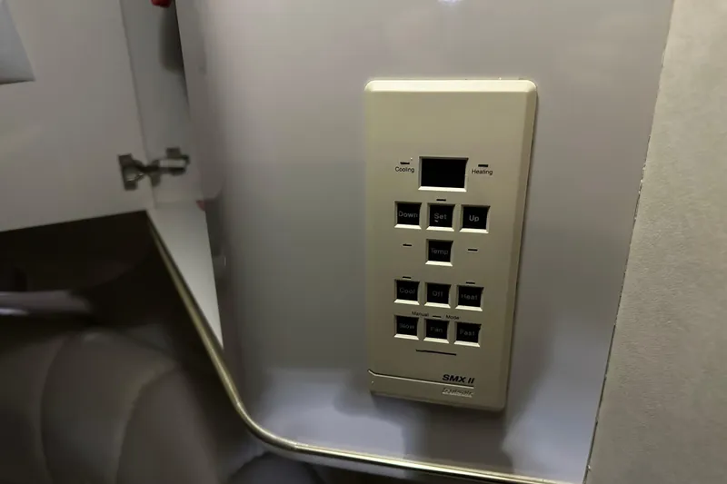 Slide: The Image of Control panel inside 1997 Sea Ray 400 Sundancer yacht, featuring temperature and fan settings. - 66