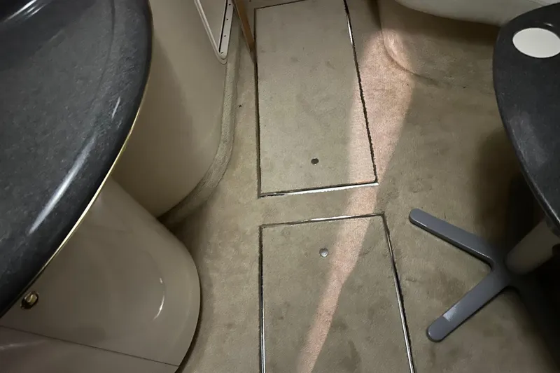 Slide: The Image of Interior of 1997 Sea Ray 400 Sundancer with carpeted flooring and sleek countertops. - 67