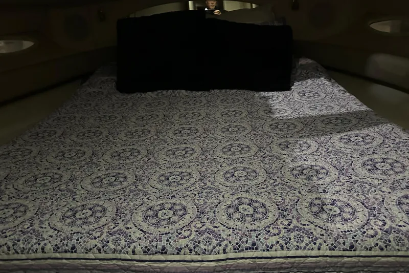 Slide: The Image of Luxurious bed inside 1997 Sea Ray 400 Sundancer yacht cabin, featuring intricate patterned bedding. - 70