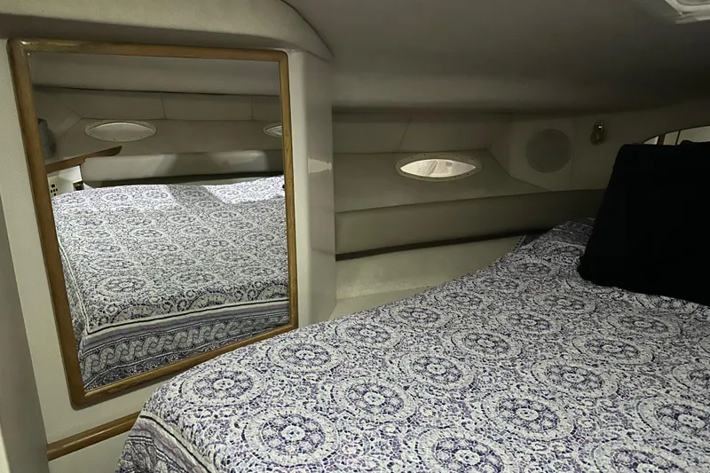 Slide: The Image of Interior cabin of 1997 Sea Ray 400 Sundancer with patterned bedding and mirror. - 71