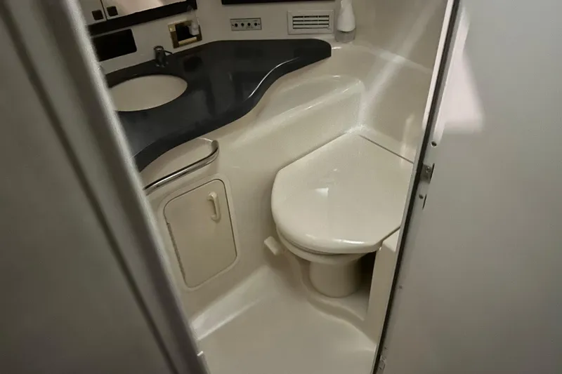Slide: The Image of Bathroom interior of 1997 Sea Ray 400 Sundancer yacht, featuring sink and toilet. - 72