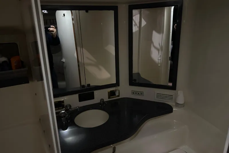 Slide: The Image of Bathroom interior of 1997 Sea Ray 400 Sundancer yacht with sink and mirrors. - 73