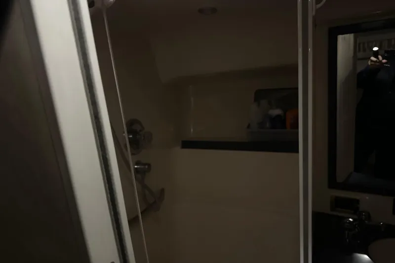 Slide: The Image of Interior of 1997 Sea Ray 400 Sundancer bathroom with shower and mirror. - 74