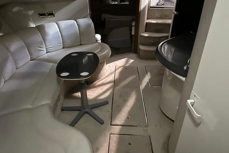Slide: The Image of Interior of 1997 Sea Ray 400 Sundancer yacht with plush seating and modern table. - 77