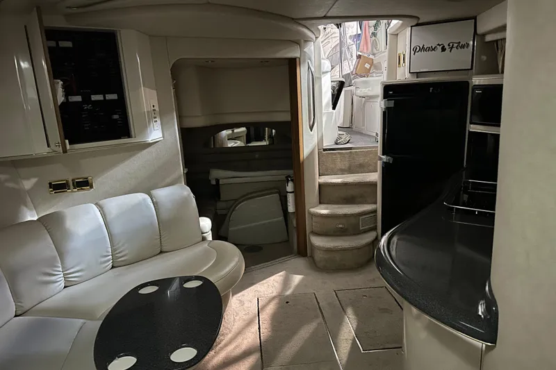 Slide: The Image of Interior of 1997 Sea Ray 400 Sundancer yacht with seating, stairs, and kitchenette. - 78