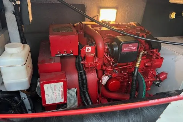 Slide: The Image of Engine compartment of a 1997 Sea Ray 400 Sundancer boat, featuring a red engine. - 86
