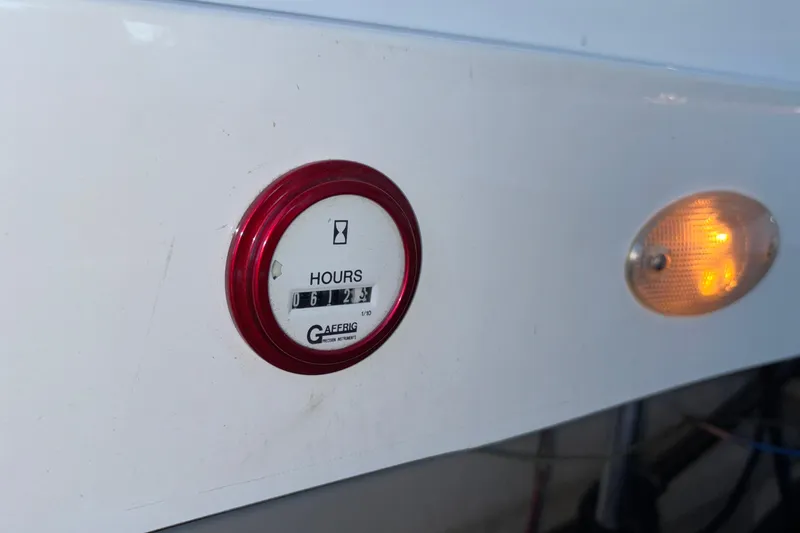 Slide: The Image of Hour meter and light on 2001 Baja 33 Outlaw boat dashboard. - 11