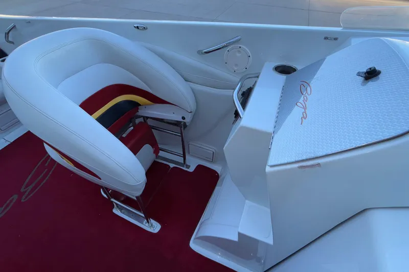 Slide: The Image of 2001 Baja 33 Outlaw boat interior with white and red seating, red carpet, and Baja logo. - 13