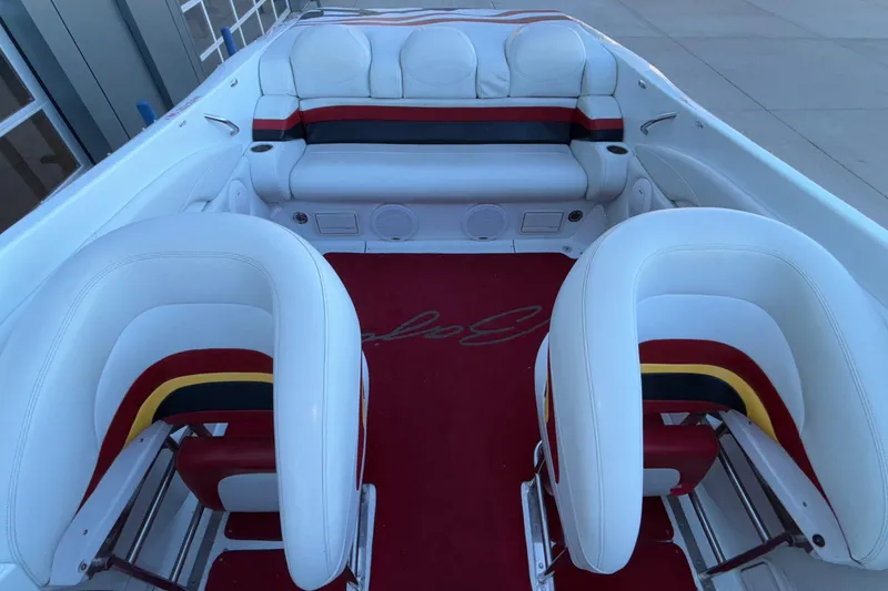 Slide: The Image of 2001 Baja 33 Outlaw boat interior with white and red seating, red carpet. - 15